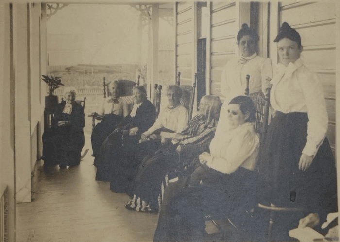 Early building with residents, circa 1893.